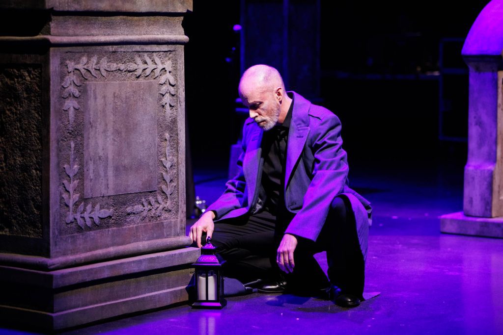 Hermann (Doug Brunker) kneels beside the grave of the Countess, in a scene from Tchaikovsky's "The Queen of Spades."