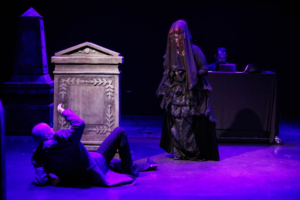 The ghost of the Countess (Yana White) frightens Hermann (Doug Brunker) in the graveyard, in a scene from Tchaikovsky's "The Queen of Spades."