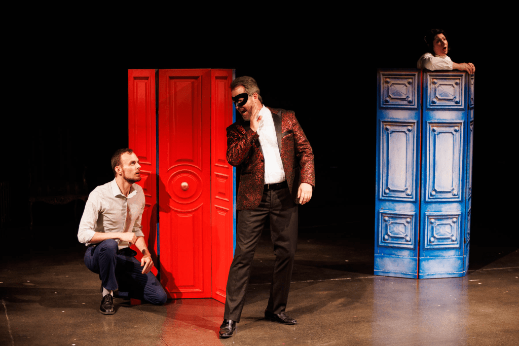 Leporello (Will Derusha, at left) and Don Giovanni (Blake Davidson, center) plan their approach as Donna Elvira (Yana White) sings in the background, in "Ah, chi mi dice mai" from Mozart's "Don Giovanni."