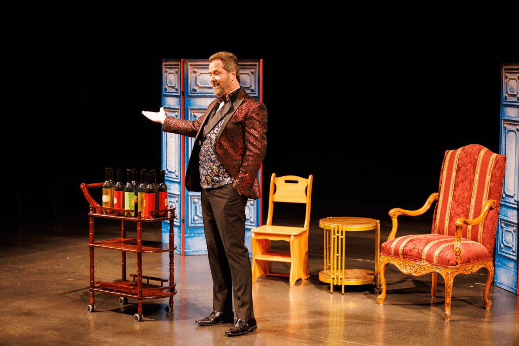 Dulcamara (Blake Davidson) displays his stock of potions in "Udite, udite, oh rustici!" from Donizetti's "The Elixir of Love".